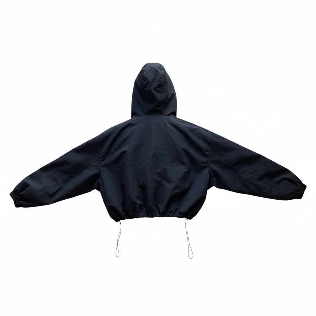 Veste coupe-vent noire Sheena avec capuche, boutons-pression et cordon de serrage, taille M/L